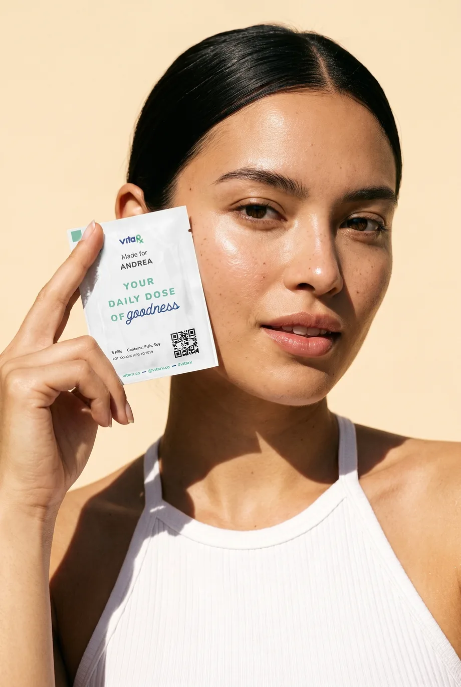 A VitaRx customer holding her daily pack