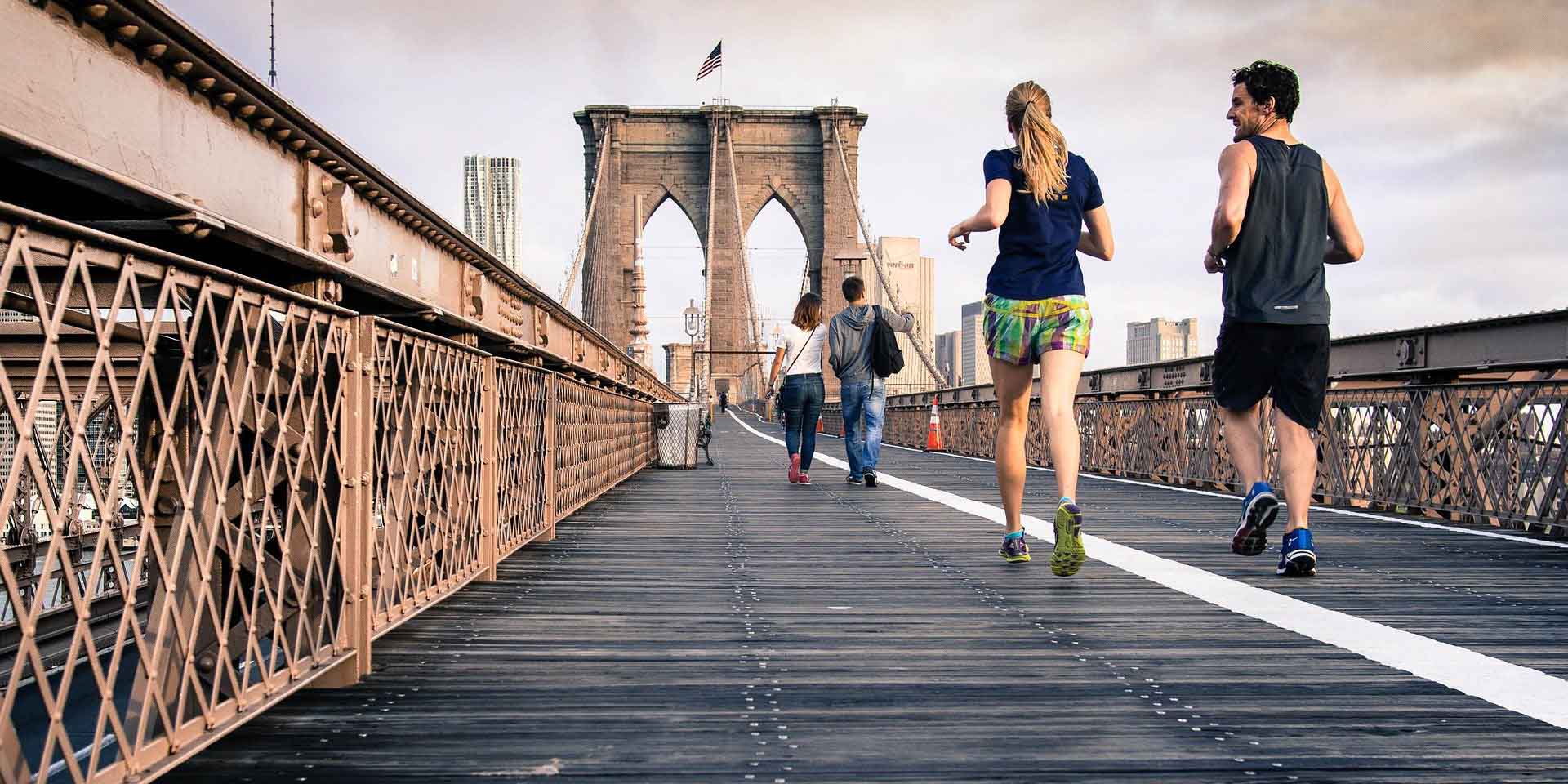 two people running on a bridge taking coq10 energy-boosting and anti-aging supplement helping them stay healthy
